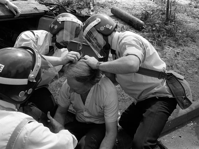 NUM leader Arthur Scargill receives treatment from ambulancemen after sustaining injuries at Orgreave