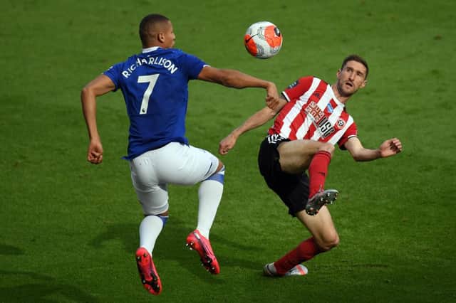 Richarlison of Everton battles for possession with Chris Basham of Sheffield United (Photo by Michael Regan/Getty Images)
