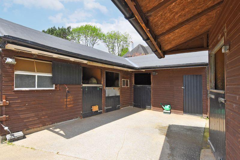 The property is a horse lovers dream, featuring four stables, a tack room, hay barn and grazing land.
