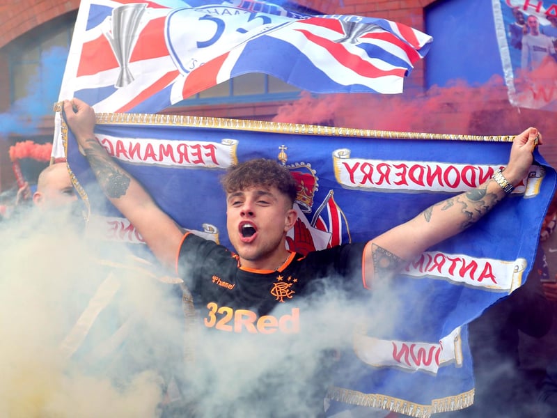 A Rangers fan celebrates outside of the Ibrox Stadium after Rangers win the Scottish Premiership title.