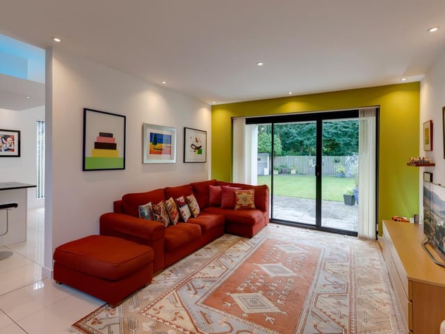Here's an alternative look at the family room - an aluminium sliding door with a double glazed panel and matching side panels opens to the front of the property.