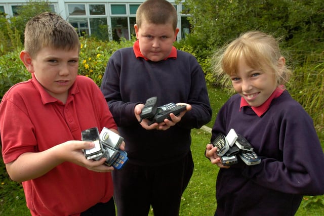 A 2009 scene and it shows Richard Jackson, Jack Cunningham and Ellie McLurg with a collection of old mobile phones which had been donated to the school. Who can tell us more?