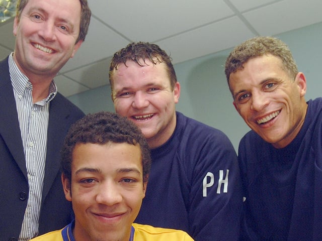 Future Premier League star Alex-John Baptiste signs for the club watched by Keith Haslam, Paul Holland and Keith Curle