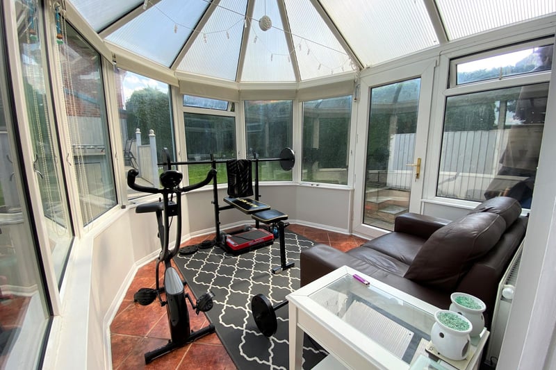 The bright and open conservatory is a flexible space offering options such as a gym or sun room.