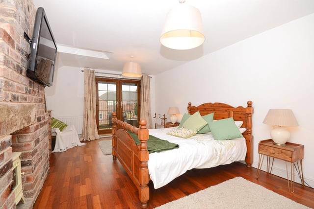 This bedroom is one of three on the first floor and offers access to a balcony.