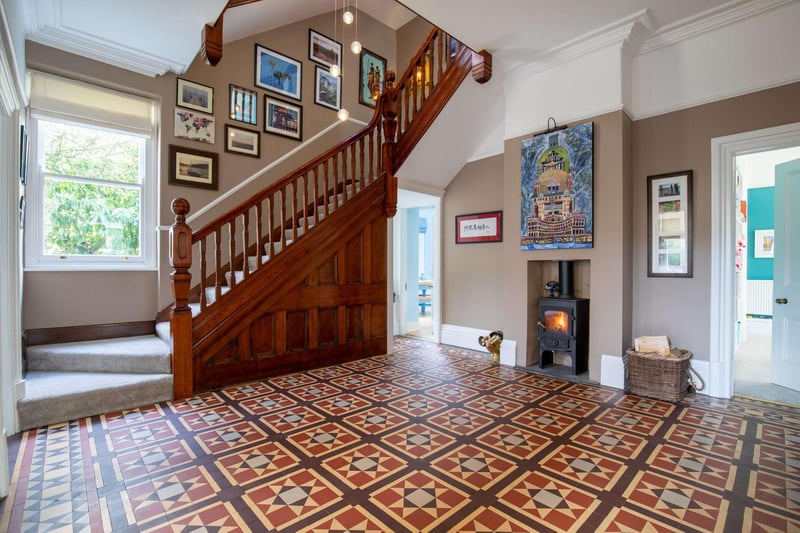 The hall features the original antique Minton ceramic floor and a reconstructed wooden staircase.
