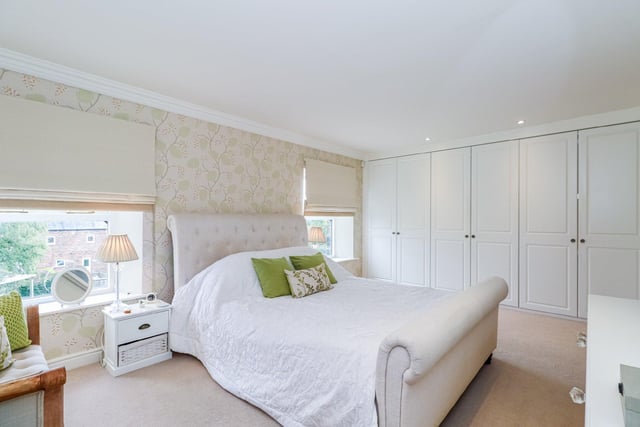 There are five generously sized bedrooms throughout the property, with this beautifully style room comprising white fitted wardrobes, two windows to the rear and an en-suite bathroom.