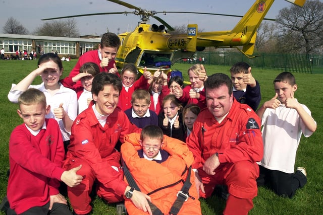 Air Ambulance pilot paramedics Sammy Wills (left) and Chris McDade  pictured with 'patient' Daniel Hudson, aged seven, and fellow Castle Hills Primary School pupils in 2004