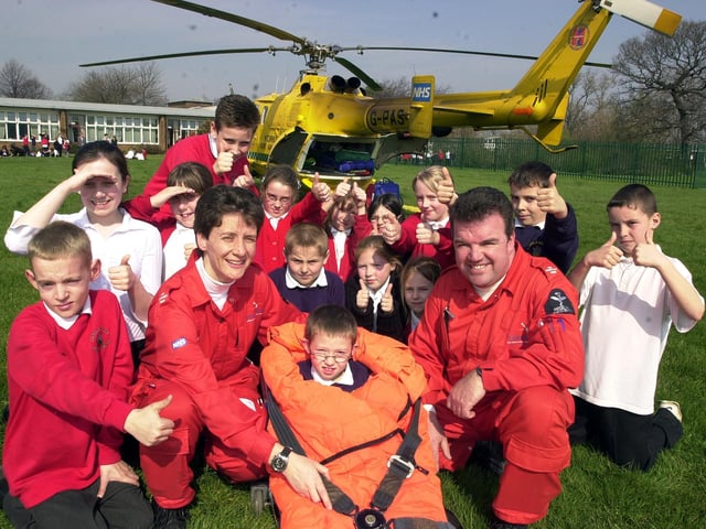 Air Ambulance pilot paramedics Sammy Wills (left) and Chris McDade pictured with 'patient' Daniel Hudson, aged seven, and fellow Castle Hills Primary School pupils in 2004