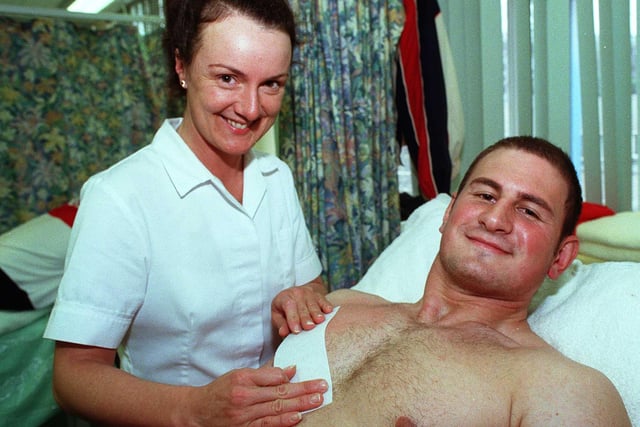 Pictured at the Hair and Beauty Dept of the Sheffield College Castle Centre in 1999, where sports personalities were having the hair waxing treatment for charity. Seen is Sheffield Eagles player Marcus Vassilokopoulos having his chest waxed by Anne Hewitt.