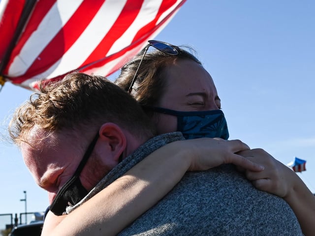 Michael Crowley and Gaby Poletaev embrace as supporters of president-elect Joe Biden celebrate his victory (Photo by ROBERTO SCHMIDT/AFP via Getty Images)