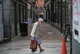 A shopper wears a face mask in the city centre of Sheffield (Photo by Oli SCARFF / AFP) (Photo by OLI SCARFF/AFP via Getty Images)