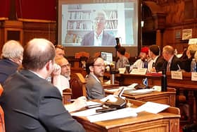 Members of Sheffield City Council watch on screens as chair of the independent inquiry into the city street trees scandal, Sir Mark Lowcock, addresses an extraordinary council meeting to discuss the report's findings. Picture: Julia Armstrong, LDRS