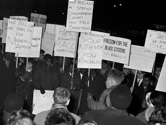 African students with placards demonstrate about the political situation in Rhodesia at the Mound in November 1965.