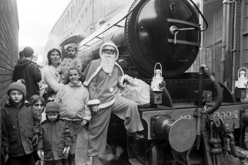 Children wait to board the Scottish Railway Preservation Society's 'Santa Special' steam train at Waverley Station, Edinburgh, in December 1988.