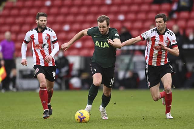 Tottenham Hotspur's Harry Kane, is challenged by Sheffield United's Chris Basham and Oliver Norwood (Stu Forster/Pool via AP)