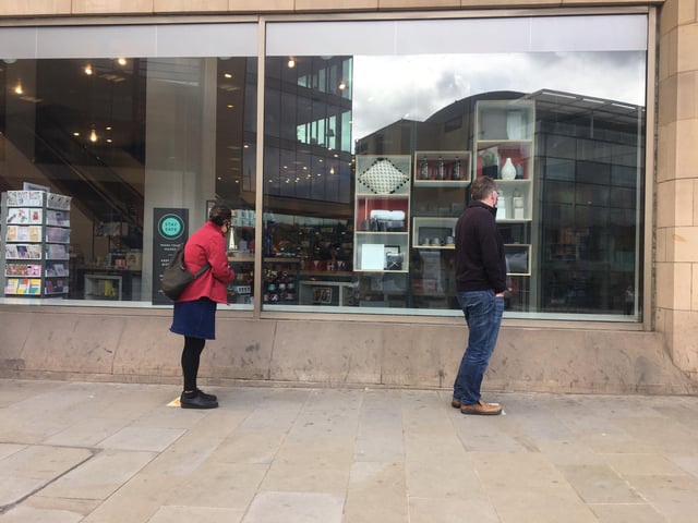 As they waited to get in, shoppers looked through the windows to see what was on offer