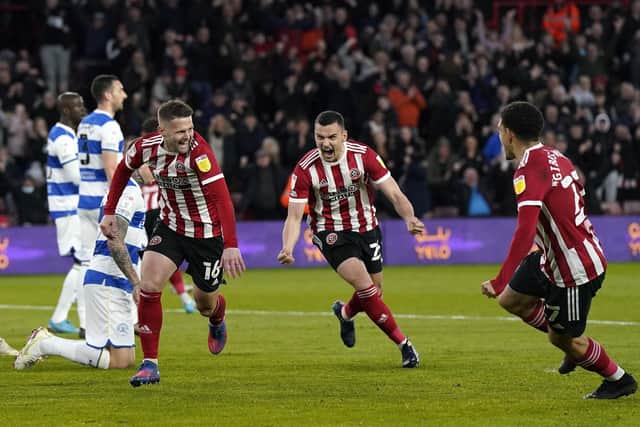 Oliver Norwood wheels away in celebration, followed by debutant Filip Uremovic, after scoring for Sheffield United against Queens Park Rangers: Andrew Yates / Sportimage