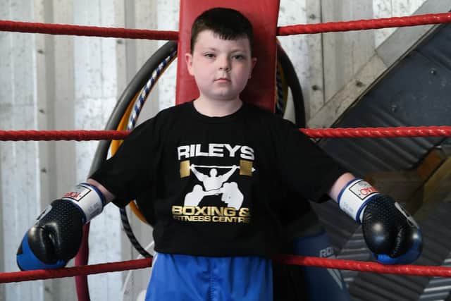 Eight-year-old boxer Lochlan Wood is holding a white collar event to raise money - with the help of Rob Riley.
