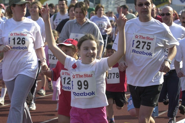 One runner races her arms in celebration back in 2004