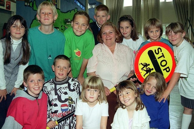 Olive Yorke,  lollipop lady at  the Herdings School, Norton Avenue, is pictured at her retirement party with some of the pupils she helps to cross the road, July 18, 1997