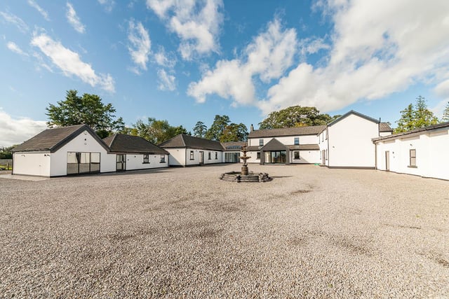 The property includes a gravel driveway and plenty of parking space with a quadruple garage. There are also seating areas, a play area and timber stables located on this 10-acre lot.