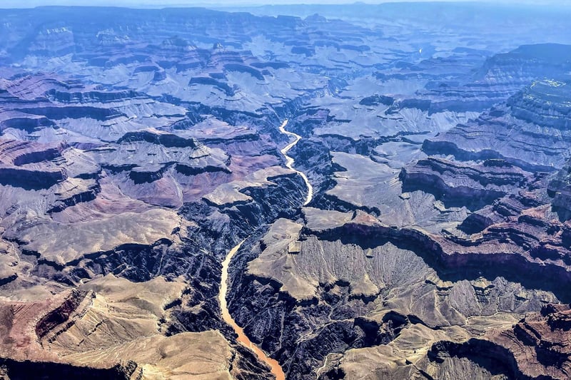 This photo provided by John Dillon shows the effects of flooding in the Colorado River through the Grand Canyon on Thursday, July 15, 2021. The river that's normally a greenish color turned a muddy brown from flash floods that have inundated Arizona. Authorities are searching for two people who were on a river rafting trip through the Grand Canyon and went missing after a flash flood, a park spokeswoman said Thursday. (John Dillon via AP)