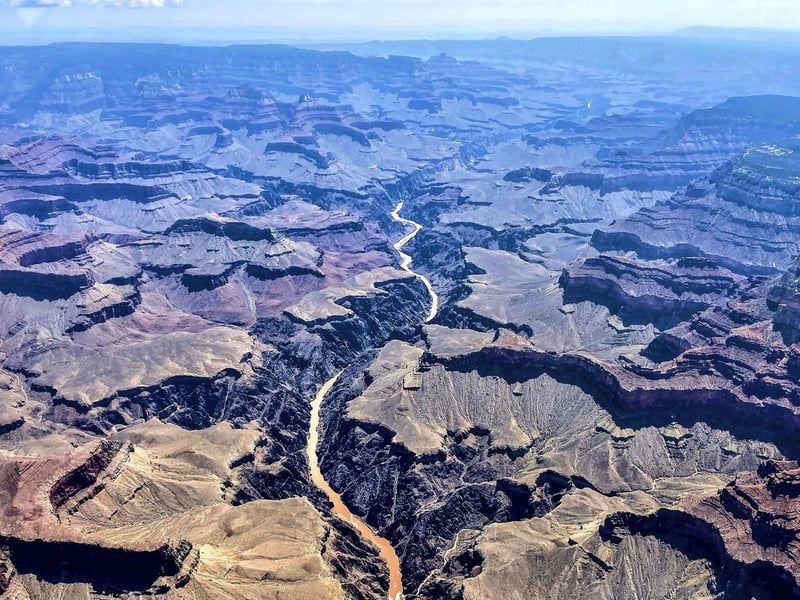 This photo provided by John Dillon shows the effects of flooding in the Colorado River through the Grand Canyon on Thursday, July 15, 2021. The river that's normally a greenish color turned a muddy brown from flash floods that have inundated Arizona. Authorities are searching for two people who were on a river rafting trip through the Grand Canyon and went missing after a flash flood, a park spokeswoman said Thursday. (John Dillon via AP)