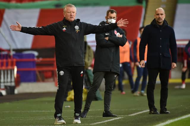 Sheffield United manager Chris Wilder (L) and Manchester City's manager Pep Guardiola look on during the English Premier League football match between Sheffield United and Manchester City at Bramall Lane  (Photo by RUI VIEIRA/POOL/AFP via Getty Images)