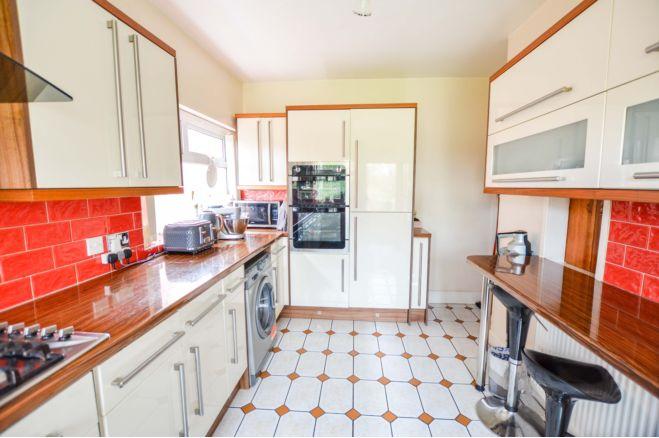 The kitchen has a range of wall and base units with work surfaces over.  Integrated appliances include fridge, freezer, dish washer, oven and grill, gas hob and extractor.  There is a one and a half sink unit with mixer tap and a breakfast bar with built in units above.