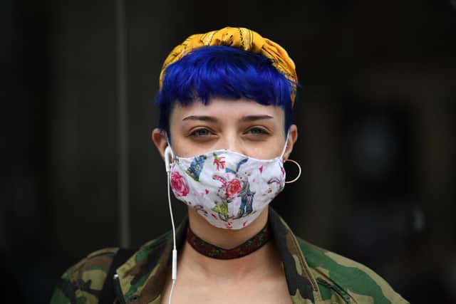 A shopper wears a face mask in the city centre of Sheffield.  (Photo by Oli SCARFF / AFP)