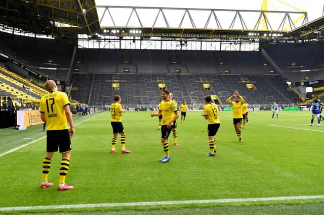 Borussia Dortmund's players celebrate scoring against Schalke at the weekend - at a safe distance. Photo by Martin Meissner/Pool via Getty Images