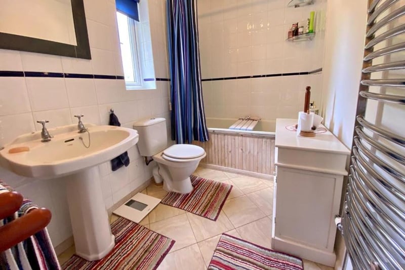 The ground-floor bathroom has quality and hardwearing Amtico vinyl flooring with an accessible underfloor area providing useful household storage. There is a white, three-piece suite comprising panelled bath with Bristan electric shower over, pedestal sink and a dual-flush WC.