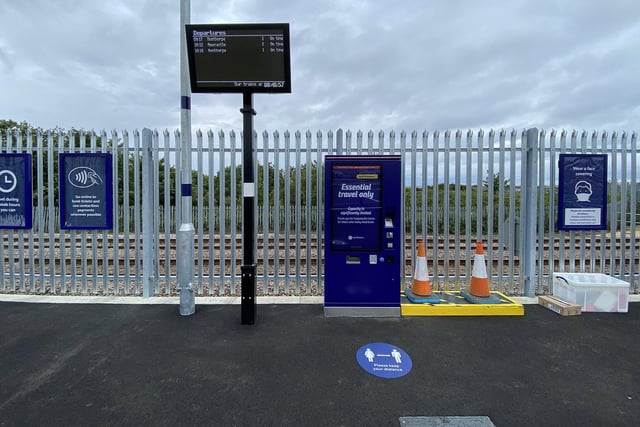 The station has ticket machines and boards announcing the timetable for services.