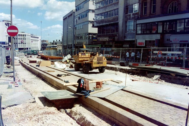 Supertram work continuing on Sheffield High Street in June 1994.  Can you remember the Saxone shoe shop pictured on the right?