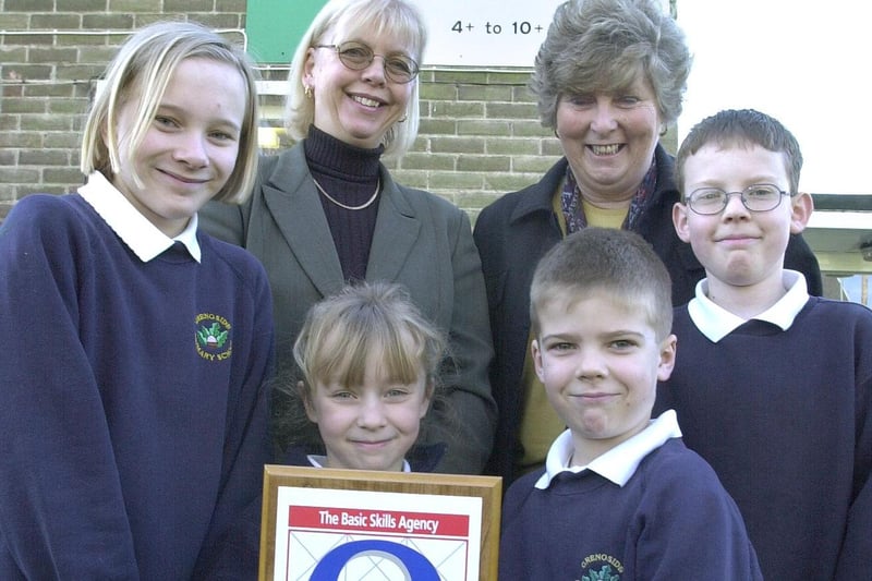 Kath Carney LEA Link Adviser rear left presented Grenoside Primary school with a Charter Mark in March 2001. Right rear is Head Pam Moody and pupils L to R front Eloise Nisbet, Rose Ambler, Jack Smith and Bradley Gyton
