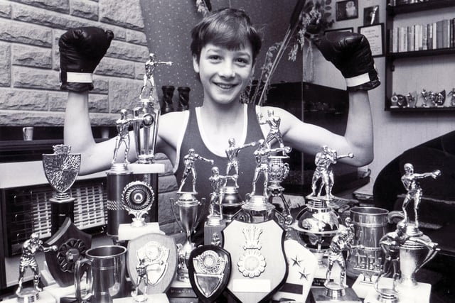 Clinton Woods, boxer, pictured with his many awards in February 1986