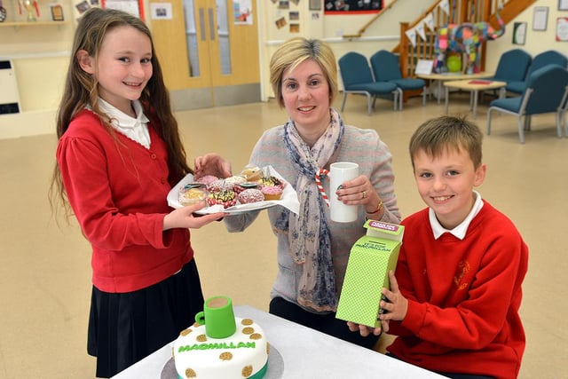 Teaching assistantFiona Davison is served cake and coffee by pupils Sage Jubb and Joe Cosgrave at St Aidan's Primary School.