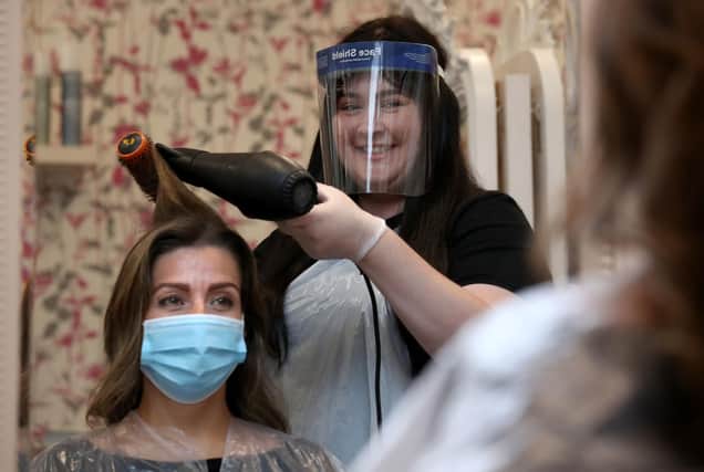 Hairdressers are among those having to get used to working in personal protective equipment