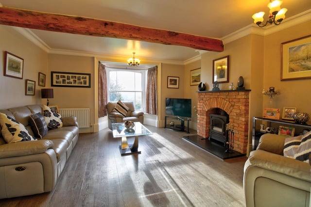 Having feature brick built fireplace with cast iron multi-fuel burner, original beams to the ceiling and bay with sash window.