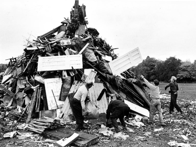 Men from the Sheffield Recreation Department build up a giant bonfire in preparation for Guy Fawkes night celebrations in Endcliffe Park, Sheffield, November 2, 1981