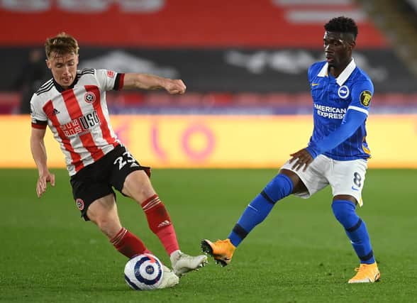 SHEFFIELD, ENGLAND - APRIL 24: Ben Osborn of Sheffield United and Yves Bissouma of Brighton & Hove Albion  battle for the ball (Photo by Michael Regan/Getty Images)