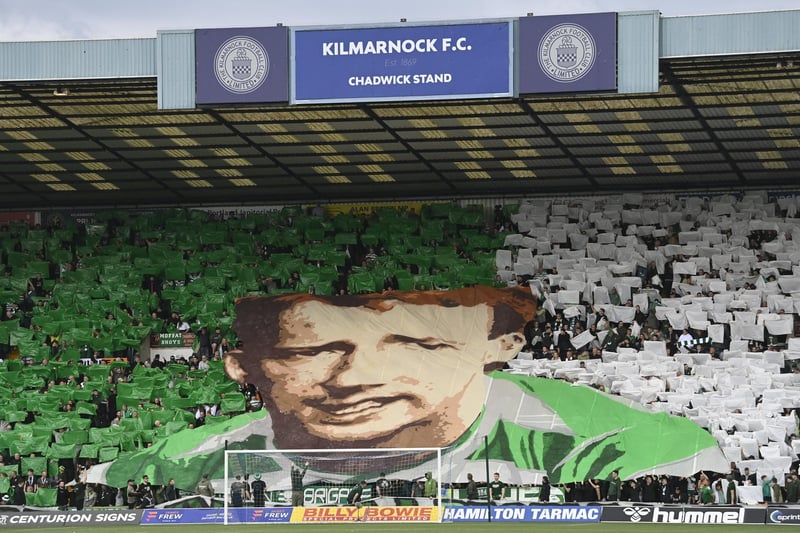 Celtic fans hold up a tifo of Tommy Burns with a banner which reads 'You're playing for a people and a cause'