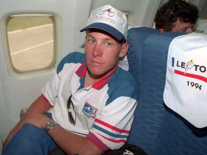 Lance Armstong relaxes in his seat on the plane taking the rides from Portsmouth to Cherbourg after Stage 5 of the Tour de France in 1994. Picture: Pascal Rondeau/ALLSPORT/ Getty Images