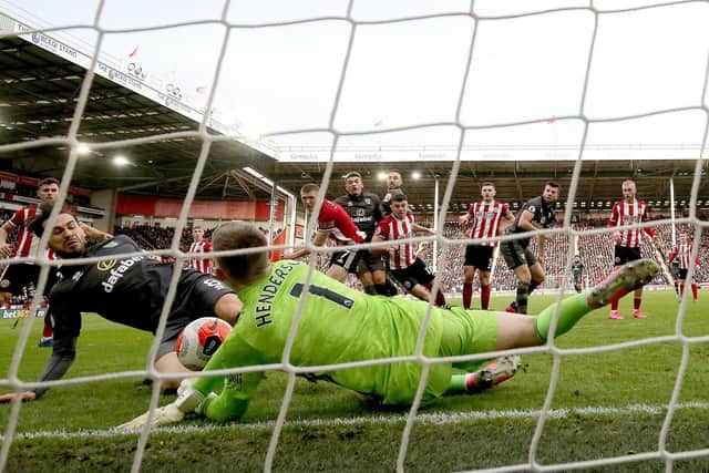 SHEFFIELD, ENGLAND - MARCH 07: Dean Henderson of Sheffield United saves a shot from Mario Vrancic of Norwich City during the Premier League match between Sheffield United and Norwich City at Bramall Lane on March 07, 2020 in Sheffield, United Kingdom. (Photo by Nigel Roddis/Getty Images)