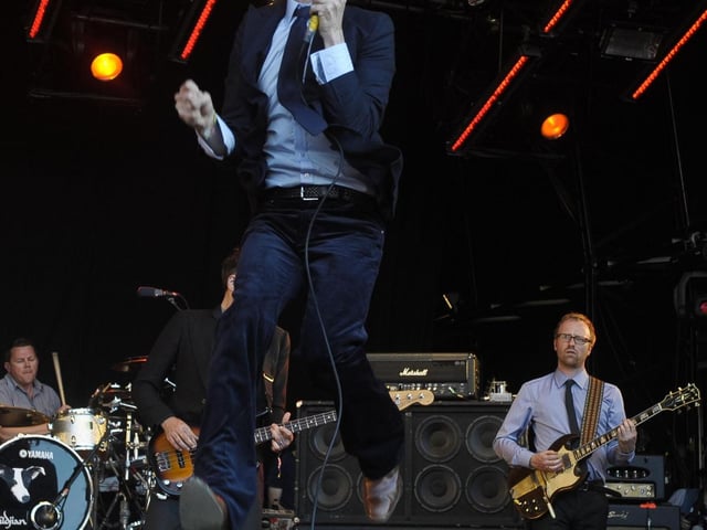 Jarvis Cocker of Pulp launching himself into the air at Glastonbury 2011