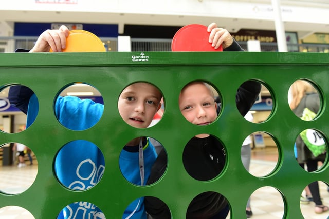 Harry Ainsley, 11, and Jack Warrington, eight, enjoy the giant Connect 4 game at Middleton Grange Shopping Centre's One Great Day charity event.