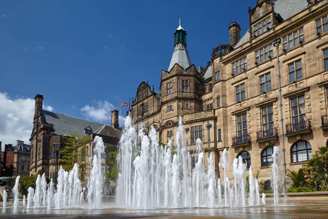 View of the fountain in the Peace Gardens with the neo-Gothic building of Sheffield Town Hall on the background. Sheffield. England  