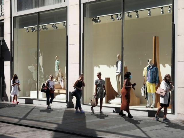 Customers follow the social distancing rules as they await entry into a newly reopened Zara store on Oxford Street in London.