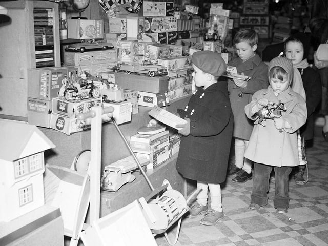 Children inspect some prospective Christmas presents in the Thornton's toy department in 1958.